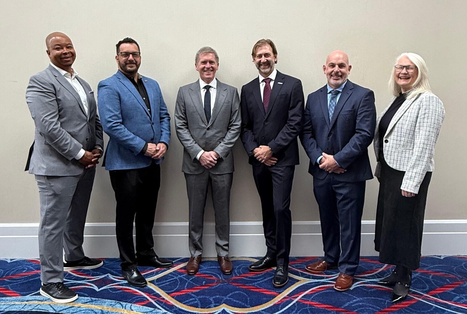 Birdon and Mythos executives stand together at Sea Air Space